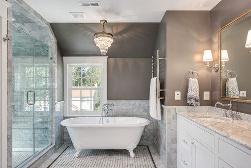 1. A spacious bathroom featuring a large tub and mirror. 2. An elegant bathroom with a big tub and mirror. 3. A luxurious bathroom with a sizable tub and mirror.